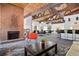 Open lounge area with a brick fireplace, pool tables, a bar, and stylish furnishings at 3465 S Poplar St # 305, Denver, CO 80224