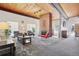 Spacious lounge area with a brick fireplace, comfortable seating, and wood-paneled ceilings at 3465 S Poplar St # 305, Denver, CO 80224