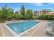 Community outdoor pool with lounge chairs and landscaping at 3465 S Poplar St # 305, Denver, CO 80224