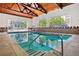 Community indoor pool with bright natural light and tall wood ceilings at 3465 S Poplar St # 305, Denver, CO 80224