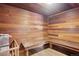 Community sauna room featuring wood benches, a wood paneled wall, and a sauna heater at 3465 S Poplar St # 305, Denver, CO 80224