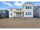 Bright, white two-story home features a covered patio and unfinished landscaping in the backyard at 16537 Black Rose Cir, Parker, CO 80134