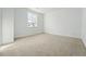 Bright bedroom with neutral carpet and windows, offering ample natural light at 16537 Black Rose Cir, Parker, CO 80134