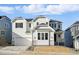 Charming two-story white home with a stone-accented facade, and an attached two-car garage at 16537 Black Rose Cir, Parker, CO 80134