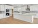 Bright kitchen featuring white cabinets, stainless steel appliances, and a center island at 16537 Black Rose Cir, Parker, CO 80134
