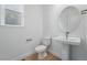Compact, clean powder room featuring modern fixtures and a pedestal sink at 16537 Black Rose Cir, Parker, CO 80134