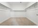 Spacious walk-in closet with shelving and neutral carpet at 16537 Black Rose Cir, Parker, CO 80134