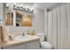 Bathroom featuring a vanity with a sink, toilet, and a shower with a curtain at 6379 Holman Ct, Arvada, CO 80004