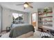 Cozy bedroom features a comfortable bed, open shelving, and a view to the ensuite bathroom at 6379 Holman Ct, Arvada, CO 80004