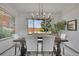 Formal dining room featuring a modern chandelier, large table, and backyard views at 6379 Holman Ct, Arvada, CO 80004