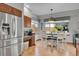 Bright kitchen and dining area with stainless steel refrigerator and a breakfast nook at 6379 Holman Ct, Arvada, CO 80004