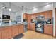 Well-lit kitchen featuring wooden cabinets, granite countertops, and stainless steel appliances at 6379 Holman Ct, Arvada, CO 80004