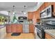 Modern kitchen featuring stainless steel appliances, granite countertops, and ample cabinet space at 6379 Holman Ct, Arvada, CO 80004