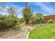 Landscaped backyard with a rock garden and blooming flowers at 6379 Holman Ct, Arvada, CO 80004
