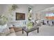 Open concept living room with views into the dining room, featuring neutral colors and large windows at 6379 Holman Ct, Arvada, CO 80004
