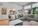 Comfortable living room with a large sectional, a view to the kitchen, and outdoor scenery at 6379 Holman Ct, Arvada, CO 80004