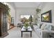 Spacious living room with comfortable seating, a large window, and an adjacent staircase at 6379 Holman Ct, Arvada, CO 80004