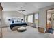 Bright and spacious main bedroom featuring plush carpeting, neutral colors, and ensuite bath at 6379 Holman Ct, Arvada, CO 80004