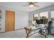 Bright home office with a modern desk, comfortable chair, and ample natural light from the windows at 6379 Holman Ct, Arvada, CO 80004