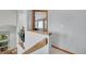 Well-lit staircase with wooden banister leading to the upper level at 6379 Holman Ct, Arvada, CO 80004
