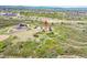 Aerial view showcasing a home nestled among lush trees, expansive acreage, and a serene rural setting at 4959 Rocky View Pt, Castle Rock, CO 80108