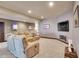 Basement living room provides a comfortable space for relaxation, complete with plush seating, TV and recessed lighting at 4959 Rocky View Pt, Castle Rock, CO 80108