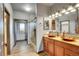Modern bathroom with dual vanities, stylish vessel sinks, a walk-in shower, and wood-look tile flooring at 4959 Rocky View Pt, Castle Rock, CO 80108