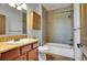 Full bathroom featuring a tub and shower, mosaic tile accents, and wood cabinetry at 4959 Rocky View Pt, Castle Rock, CO 80108