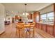 An open kitchen and dining area with wood floors and cabinets at 4959 Rocky View Pt, Castle Rock, CO 80108
