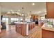 Open kitchen featuring a large island, gas stovetop, wood cabinets, and seamless flow to the living area at 4959 Rocky View Pt, Castle Rock, CO 80108
