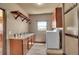 Functional laundry room with cabinets, folding counter, window, and modern washer and dryer at 4959 Rocky View Pt, Castle Rock, CO 80108