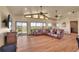 Bright living room with hardwood floors, vaulted ceilings, and a large sectional couch at 4959 Rocky View Pt, Castle Rock, CO 80108