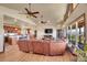 Bright living room with wood floors, vaulted ceilings, fireplace, and open layout, flowing into the dining area at 4959 Rocky View Pt, Castle Rock, CO 80108