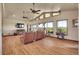 Open living room with wood floors, vaulted ceilings, ample windows, and a cozy fireplace showcasing scenic views at 4959 Rocky View Pt, Castle Rock, CO 80108