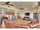 The expansive living room features an open layout with wood floors, a modern kitchen and dining area at 4959 Rocky View Pt, Castle Rock, CO 80108