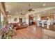 Large open living room with wood floors, an expansive kitchen, and comfortable seating area, creating a cozy ambiance at 4959 Rocky View Pt, Castle Rock, CO 80108