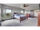 Bright bedroom with a king bed, scenic views from two windows, and light-colored walls for a serene atmosphere at 4959 Rocky View Pt, Castle Rock, CO 80108