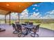 Covered patio features an outdoor dining area and scenic views of the surrounding landscape and trees at 4959 Rocky View Pt, Castle Rock, CO 80108
