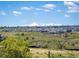 Picturesque view showcasing snow-capped mountains in the distance and neighborhood with green foreground at 4959 Rocky View Pt, Castle Rock, CO 80108