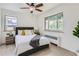 Bright bedroom featuring a ceiling fan, windows, and modern decor at 2100 N Franklin St # 20, Denver, CO 80205