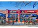 Restaurant exterior with outdoor seating and blue umbrellas at 2100 N Franklin St # 20, Denver, CO 80205