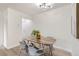 Cozy dining room featuring a modern light fixture and a charming wooden table with gray chairs at 2100 N Franklin St # 20, Denver, CO 80205
