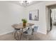 Contemporary dining room with sleek light fixture and stylish art piece with wood dining table and four gray chairs at 2100 N Franklin St # 20, Denver, CO 80205