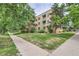 Exterior view of the home with surrounding grassy lawn and sidewalk access at 2100 N Franklin St # 20, Denver, CO 80205