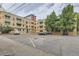Brick building with parking, green awnings, and mature trees at 2100 N Franklin St # 20, Denver, CO 80205