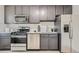 Updated kitchen featuring stainless steel appliances, gray cabinets, and modern countertops at 2100 N Franklin St # 20, Denver, CO 80205