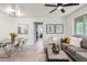 Open floor plan showcasing living room with sofa, chairs, table and art and dining room with seating for four at 2100 N Franklin St # 20, Denver, CO 80205