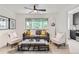Comfortable living room featuring a gray sofa, stylish white chairs, and modern decor, great natural light from a large window at 2100 N Franklin St # 20, Denver, CO 80205