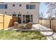 Relaxing back patio featuring modern outdoor seating and a view into the living area at 4201 Vallejo St, Denver, CO 80211