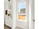Bright bathroom with a sleek vanity, pendant lighting, and a large window offering natural light and an outside view at 4201 Vallejo St, Denver, CO 80211